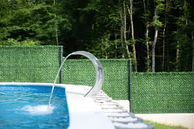 a swimming pool with a water fountain at Villa Tea - Slatina in Laktaši