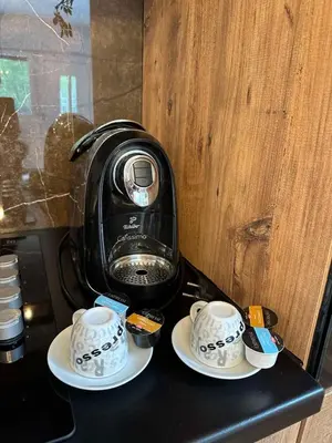 a coffee maker sitting on top of a black counter at Villa Tea - Slatina in Laktaši