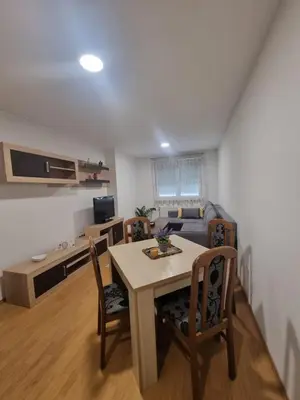 a living room with a table and chairs and a couch at CityLux Doboj in Doboj