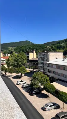a city with cars parked in a parking lot at MG in Žepče