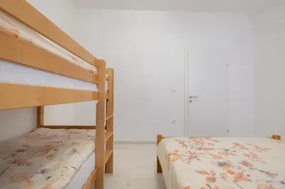 a bedroom with two bunk beds and a closet at Apartman BARIŠIĆ 1 in Kupres