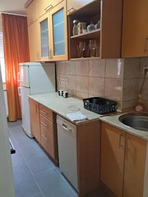 a small kitchen with a sink and a refrigerator at Apartman 2E in Tuzla