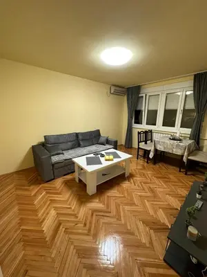 a living room with a couch and a table at Apartman 2E in Tuzla