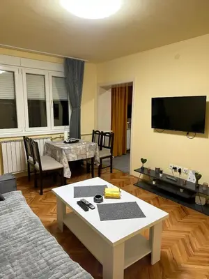 a living room with a couch and a table at Apartman 2E in Tuzla