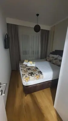 a bedroom with a large bed with flowers on it at Apartman Ada Banja Luka in Rebrovac