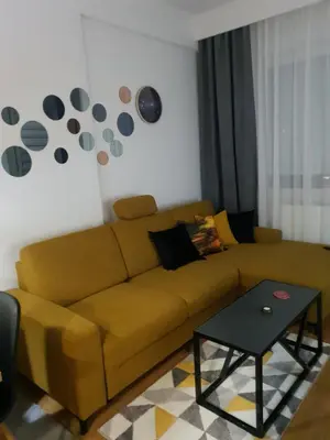 a living room with a brown couch and a table at Apartman Ada Banja Luka in Rebrovac