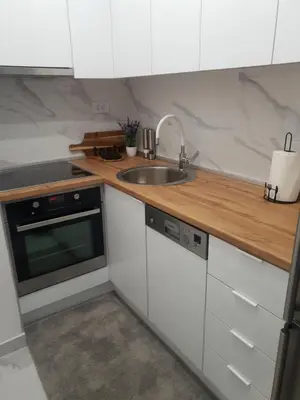 a kitchen with white cabinets and a sink at Apartman Ada Banja Luka in Rebrovac