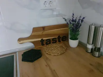 a wooden bench sitting on top of a counter with flowers at Apartman Ada Banja Luka in Rebrovac