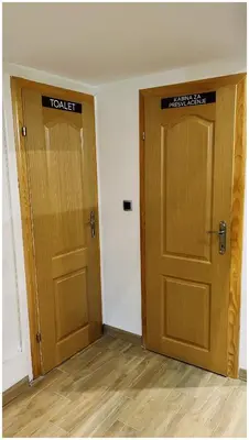 two wooden doors in a room with wooden floors at Villa Almedina Spa in Vlasic