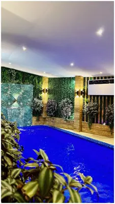 a swimming pool in a building with blue water at Villa Almedina Spa in Vlasic