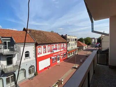 a view of a street with red and white buildings at Apartman MARIJA in Bosanski Šamac
