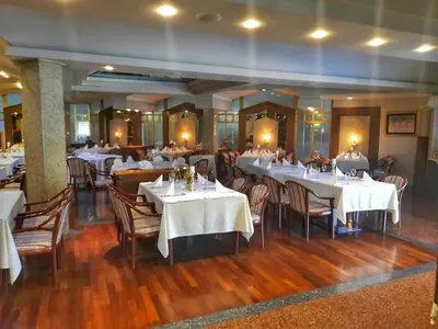 a restaurant with tables and chairs with white table cloth at Hotel Bacchus in Livno