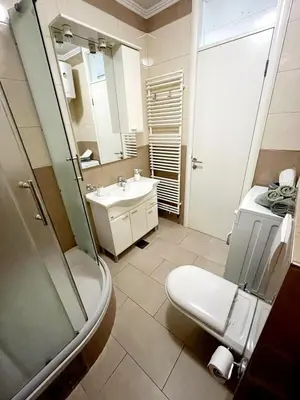 a bathroom with a toilet and a sink at Apartments Family House in Banja Luka