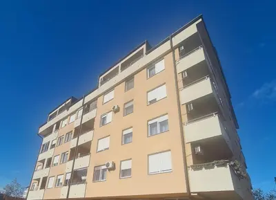 a tall apartment building against a blue sky at Apartments Family House in Banja Luka