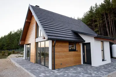 a small house with a black roof at Strane in Tomislavgrad