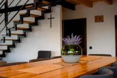 a vase with purple flowers sitting on a table at Strane in Tomislavgrad