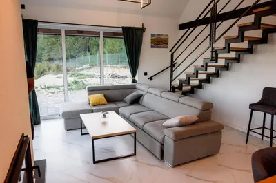 a living room with a couch and a table at Strane in Tomislavgrad