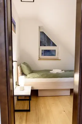 a small bedroom with a bed and a window at Strane in Tomislavgrad