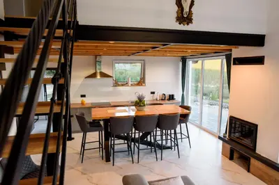 a dining room with a wooden table and chairs at Strane in Tomislavgrad