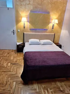 a bedroom with a bed with two pillows on it at centar apartment in Banja Luka