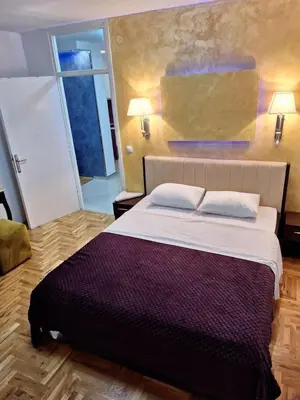 a bedroom with a large bed with two pillows at centar apartment in Banja Luka