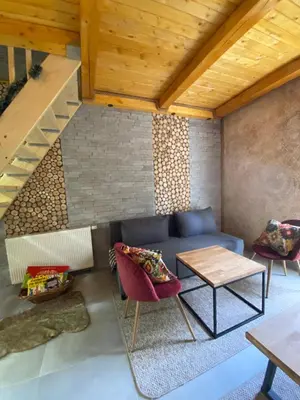 a living room with a blue couch and a table at Apartmani Snježna Kraljica Vlašić 1 in Vlasic