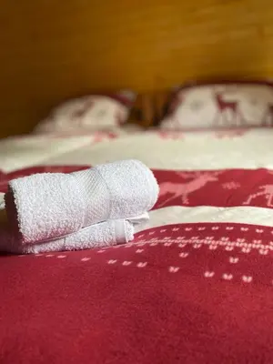 a pair of white socks sitting on top of a bed at Apartmani Snježna Kraljica Vlašić 1 in Vlasic