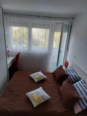 a bedroom with a bed with two pillows on it at Apartman OMANOVIĆ in Bihać