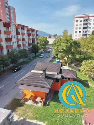 a view of a building with a street and buildings at Apartman OMANOVIĆ in Bihać