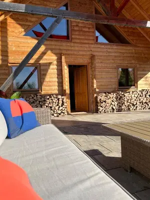 a log cabin with a bench in front of it at Wood Cabin Hillside Retreat in Banja Luka