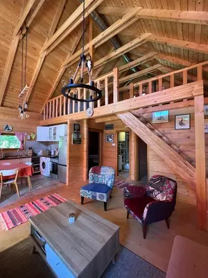 a large living room with a wooden ceiling at Wood Cabin Hillside Retreat in Banja Luka