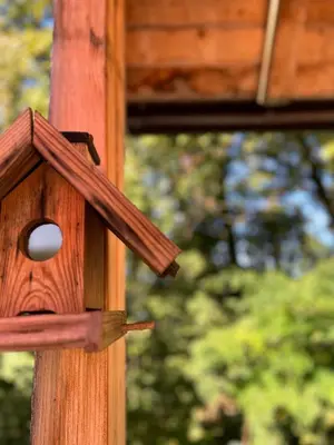 a wooden bird house on a wooden pole at Wood Cabin Hillside Retreat in Banja Luka