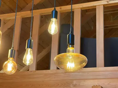 a group of lights hanging from a ceiling at Wood Cabin Hillside Retreat in Banja Luka