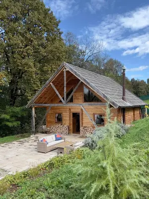 a large log cabin with a roof at Wood Cabin Hillside Retreat in Banja Luka