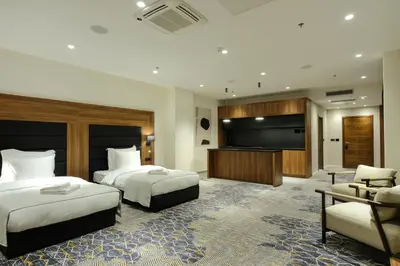 a hotel room with two beds and a flat screen tv at Hotel Vema in Visoko