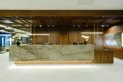 a lobby with a large marble reception desk at Hotel Vema in Visoko