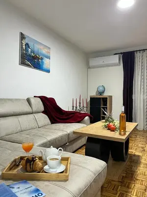 a living room with a couch and a table at Stan na dan Kozarska Dubica in Bosanska Dubica