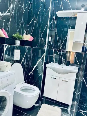 a bathroom with a white toilet and a sink at Stan na dan Kozarska Dubica in Bosanska Dubica