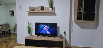 a flat screen tv sitting on a table in a living room at Stan na dan Kozarska Dubica in Bosanska Dubica