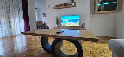 a living room with a table with a television on it at Stan na dan Kozarska Dubica in Bosanska Dubica