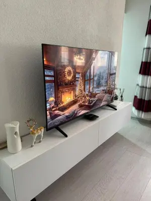 a flat screen tv sitting on top of a white entertainment center at Stan na dan Hasanovic in Tuzla