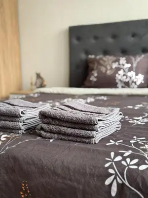 a pile of towels sitting on top of a bed at Stan na dan Hasanovic in Tuzla