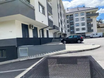a car parked in a parking lot next to some buildings at Zeus in Hiseti