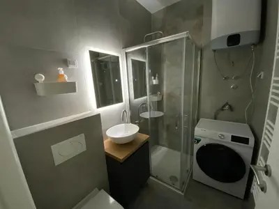 a bathroom with a sink and a shower and a toilet at Zeus in Hiseti