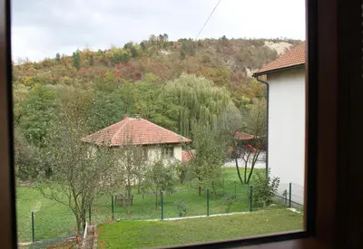 a view from a window of a yard with a building at Restart Apartment in Visoko