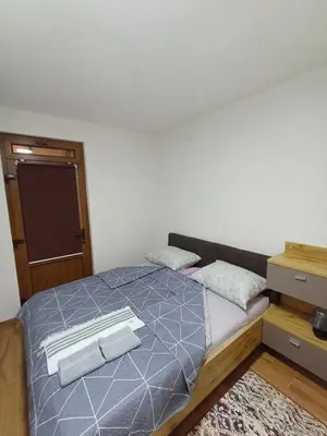 a bedroom with a bed with two towels on it at Restart Apartment in Visoko