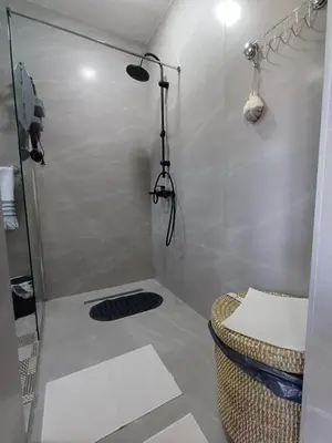 a shower with a glass door in a bathroom at Restart Apartment in Visoko