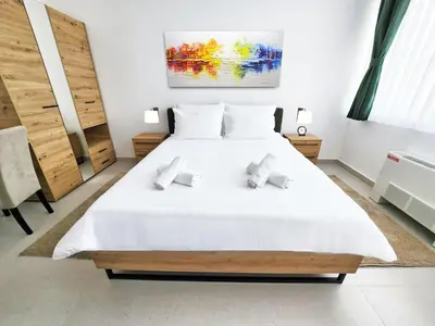 a bedroom with a large white bed with two pillows at Hotel Balon in Velika Kladuša