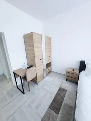 a bedroom with a desk and a bed and a dresser at Hotel Balon in Velika Kladuša