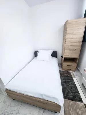 a bedroom with a bed and a wooden dresser at Hotel Balon in Velika Kladuša
